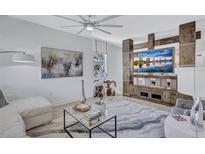 Bright living room features modern decor, stylish furniture, and a custom entertainment center at 1119 Highland S St, St Petersburg, FL 33701