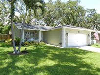 Charming single-story home featuring a well-manicured lawn and tasteful landscaping at 1212 Rosewood St, Largo, FL 33770
