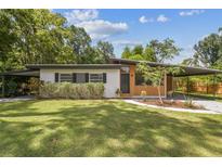 Charming single story home featuring a well maintained lawn and a covered carport at 1402 E Mimosa Dr, Plant City, FL 33563