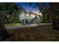Charming two-story home on stilts with a well-maintained yard and stairs to front door at 34147 Ringwalt Dr, Dade City, FL 33523