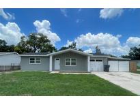 Charming single-story home featuring a stone facade, well-maintained lawn, attached garage and driveway at 3803 43Rd N Ave, St Petersburg, FL 33714