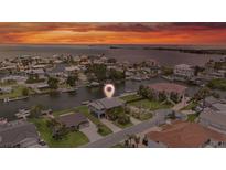 Sunset view of waterfront home nestled amongst lush landscaping on a canal with easy bay access at 4279 Newport Dr, Hernando Beach, FL 34607