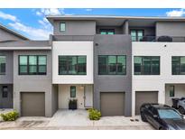 Contemporary townhome featuring neutral color palette, private balconies, and attached garages for convenient parking at 8714 Palm Ranches Pl, Tampa, FL 33614