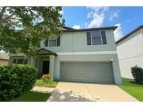 Charming two-story home with a well-manicured lawn and a two-car garage at 10108 Rosemary Leaf Ln, Riverview, FL 33578