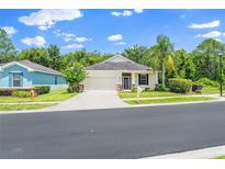 Charming single-story home featuring a well-manicured lawn and a two-car garage, perfect for suburban living at 11144 Paradise Point Way, New Port Richey, FL 34654