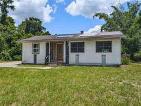 Quaint single-story home featuring a grass front yard and a traditional-style entrance at 12704 Lacey, New Port Richey, FL 34654
