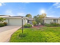 Charming single-story home features a well-manicured lawn and a two-car garage at 1306 Idlewood Dr # 53, Sun City Center, FL 33573