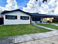 Charming single-story home featuring a well-maintained lawn and a covered carport at 2509 Thornbrook Pl, Tampa, FL 33618