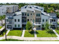 Modern townhome with balconies, manicured lawn, and fresh landscaping in a desirable community at 2568 13Th N Ave # 2568, St Petersburg, FL 33713