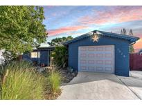 Charming single Gathering home features an attached garage, nicely landscaped front yard, and lovely exterior paint at 3628 Holiday Lake Dr, Holiday, FL 34691
