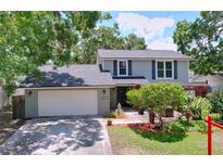 Charming two-story home featuring lush landscaping, a welcoming entrance and a two-car garage at 4030 Braesgate Ln, Tampa, FL 33624