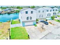 Stunning waterfront home with a well-manicured lawn, private dock, and two-car garage at 5253 Boardwalk St, Holiday, FL 34690