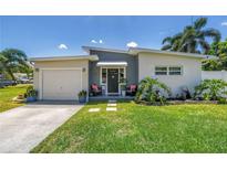 Charming single Gathering home featuring a well maintained lawn and welcoming front entry way at 5401 7Th N Ave, St Petersburg, FL 33710