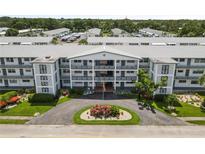 An inviting condominium building with well-maintained landscaping and a circular driveway at 6000 20Th N St # 123, St Petersburg, FL 33714