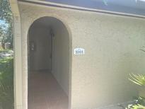 Welcoming front entrance featuring a unique archway and house number at 6262 142 N Ave # 1001, Clearwater, FL 33760