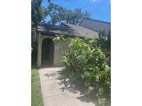 Charming entryway with lush greenery and a decorative arch at 6262 142 N Ave # 1001, Clearwater, FL 33760