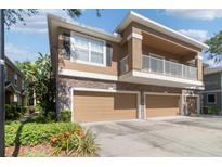Charming townhome with a two-car garage, balcony, and stone accents at 7001 Interbay Blvd # 219, Tampa, FL 33616