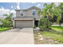 Charming two-story home featuring a two-car garage and well-maintained landscaping at 15420 Quail Woods Pl, Ruskin, FL 33573