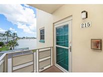 Balcony view with water and palm trees outside unit 215 at 2960 59Th S St # 215, Gulfport, FL 33707