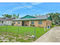 Charming single-story home featuring a well-maintained lawn and a classic stucco facade at 312 E Tomlin St, Plant City, FL 33563