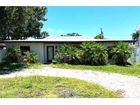 Charming single-story home featuring mature landscaping and a brick driveway at 3811 Huntington Ne St, St Petersburg, FL 33703