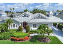 Charming single-story home with meticulously landscaped yard and a distinctive red front door at 4743 Spinnaker Dr, Bradenton, FL 34208