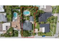 A captivating aerial view showcases this home and its large yard, complete with a pool and patio at 58 Aster St, Clearwater Beach, FL 33767