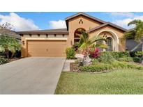 Charming single-story home featuring a two-car garage and well-maintained landscaping at 7408 Sungold Meadow Ct, Apollo Beach, FL 33572