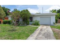 Charming single-story home featuring a well-maintained lawn, mature trees and landscaping at 760 72Nd N Ave, St Petersburg, FL 33702