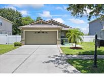 Charming single-story home featuring a well-manicured lawn, neutral paint, and a spacious two-car garage at 9831 Edmonton Dr, Land O Lakes, FL 34638