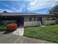 Charming single-story home with a well-maintained lawn and vibrant red bushes under a sunny sky at 1508 16Th Se Cir, Largo, FL 33771
