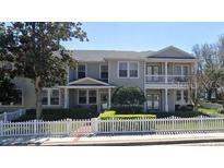 Charming two-story townhome featuring a white picket fence and welcoming front porches at 291 1St Sw Ave, Largo, FL 33770