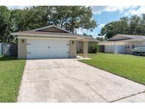 Charming single-story home with a well-maintained lawn and a two-car garage at 3226 Coventry N, Safety Harbor, FL 34695