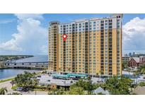 High-rise building featuring a vibrant yellow facade and balconies, nestled near waterfront and city views at 345 Bayshore Blvd # 1510, Tampa, FL 33606