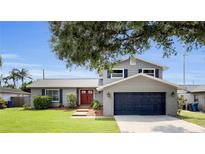 Charming two-story home with a well-manicured lawn and inviting red double-door entrance, creating a welcoming curb appeal at 3721 Casaba Loop, Valrico, FL 33596