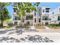 Contemporary townhomes with stone accents, black metal fences, and landscaped front yards add curb appeal at 50 64Th S St, St Petersburg, FL 33707