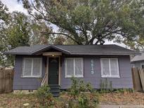 Quaint single-story home featuring a covered entrance, updated roof, and freshly painted gray siding at 6515 30Th N St, St Petersburg, FL 33702