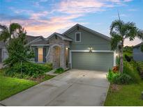 Charming single-Gathering home featuring a manicured lawn, two car garage and stone accents at 8119 Trimbelle Ter, Parrish, FL 34219