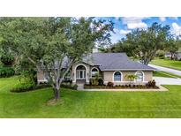 Charming one-story home with a beautifully landscaped front yard and arched entryway at 8901 Eagle Watch Dr, Riverview, FL 33578