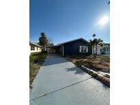 Charming single-story home with a well-maintained lawn and a long driveway at 15416 2Nd E St, Madeira Beach, FL 33708