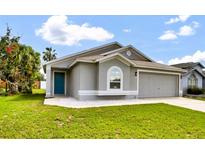 Well-maintained single-Gathering home with a gray exterior and a two-car garage at 1706 Erin Brooke Dr, Valrico, FL 33594