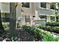 Condo exterior with a private gated patio, manicured bushes, and fresh mulch at 269 Los Prados Dr # 1011, Safety Harbor, FL 34695
