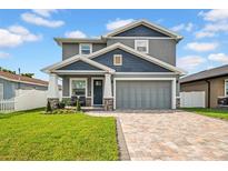 Charming two-story home with a well-manicured lawn and a beautifully paved driveway, enhancing its curb appeal at 3013 W Crest Ave, Tampa, FL 33614