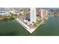 Expansive aerial view of the building showing a marina, covered parking, and surrounding neighborhood at 31 Island Way # 502, Clearwater Beach, FL 33767