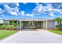 Charming home with a covered parking area and well-maintained landscaping at 37526 New Horizons Blvd, Zephyrhills, FL 33541