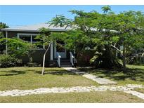 Charming home with lush landscaping and stone walkway, perfect for curb appeal at 4350 2Nd S Ave, St Petersburg, FL 33711