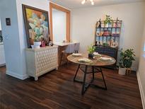Bright dining room featuring dark wood flooring and a charming round dining table at 5925 Terrace Park N Dr # 210, St Petersburg, FL 33709