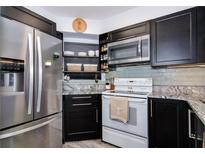 Updated kitchen features stainless steel refrigerator, granite counters and abundant cabinet space at 6932 Stones Throw N Cir # 7101, St Petersburg, FL 33710