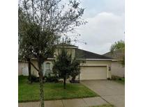 Charming single-Gathering home with a well-manicured lawn and a two-car garage at 7931 Camden Woods Dr, Tampa, FL 33619