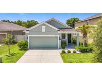 Charming single-Gathering home showcasing a well-maintained lawn and a two-car garage at 13806 Reindeer Cir, Hudson, FL 34669